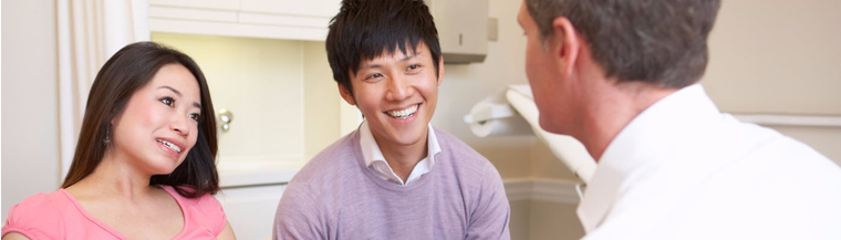 Couple talking to doctor. Couple talking to doctor.