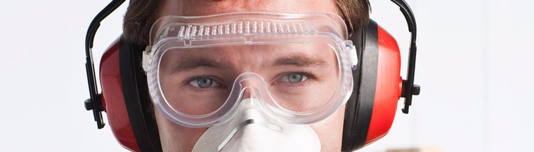 Man wearing dust mask and ear defenders. Man wearing dust mask and ear defenders.