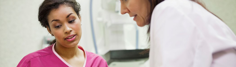 Doctor discussing hysterectomy with female patient. Doctor discussing hysterectomy with female patient.