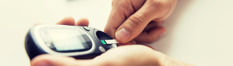 Man testing his blood glucose level with a glucometer. Man testing his blood glucose level with a glucometer.