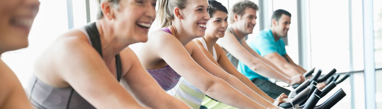 People on exercise bikes. People on exercise bikes.