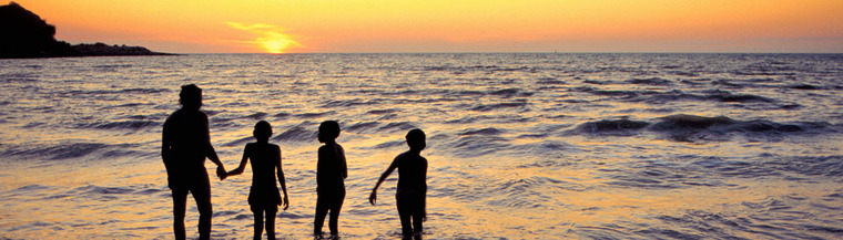 Silhuettes of father and sons in water. Silhuettes of father and sons in water.