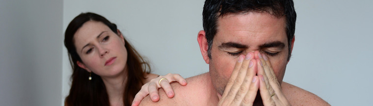 Couple sitting down in bedroom. Couple sitting down in bedroom.