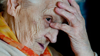 old-woman-holding-head-video-index.jpg Dementia gradually gets worse overtime and is more common in older people.